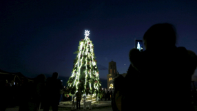 Muslims and Christians unite under Christmas tree on site of Jesus\' baptism