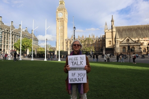 Livia Tossici-Bolt with her sign in front of the Houses of Parliament